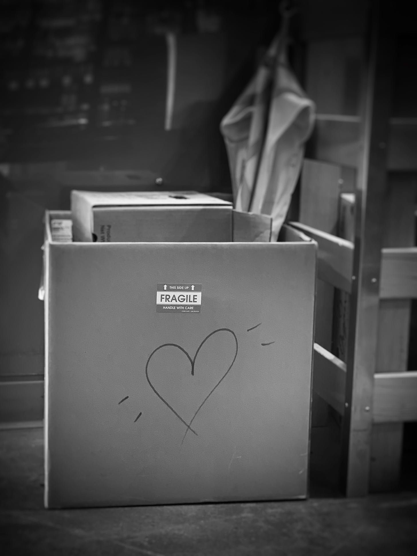 Cardboard box marked fragile with a hand-drawn heart