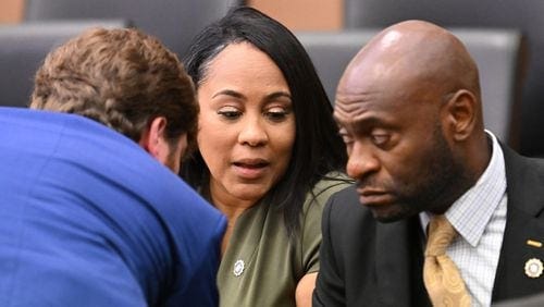 Fulton DA Fani Willis, center, confers with lead prosecutors, Donald Wakeford, left, and Nathan Wade, during a hearing at the Fulton County Courthouse in Atlanta on July 1, 2022. (Hyosub Shin/The Atlanta Journal-Constitution/TNS)