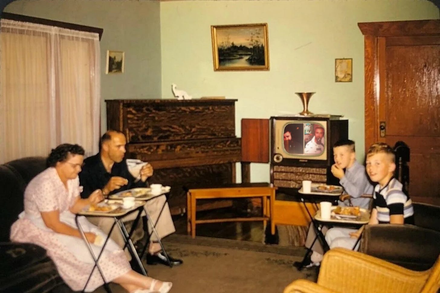 A vintage photo of a family in a living room, eating dinner off of TV trays, with an image from the Kelce Brothers' podcast edited onto the television screen.