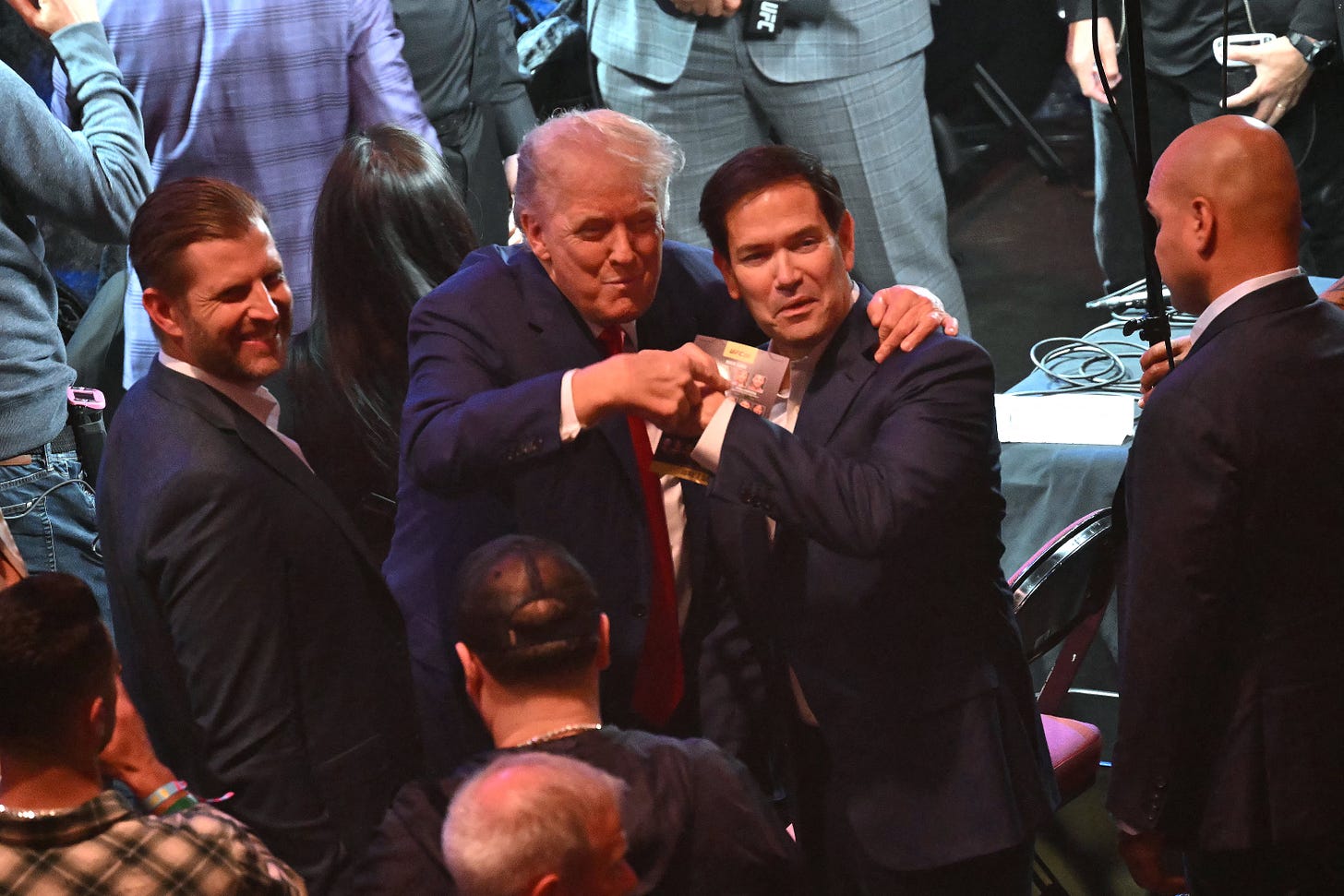 Trump laughs with his son Eric, left, and Secretary of State Marco Rubio, center Trump laughs with his son Eric, left, and Secretary of State Marco Rubio, center
