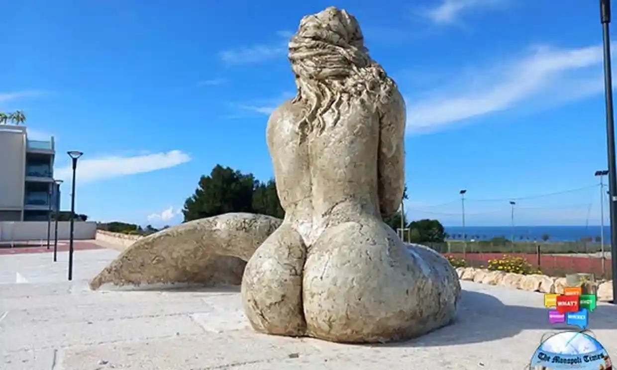 ID: a behind shot of a busty mermaid statue where you can see her ample butt and butt crack