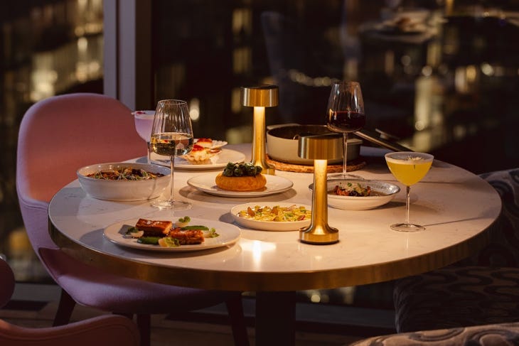 A restaurant table lit only by candles