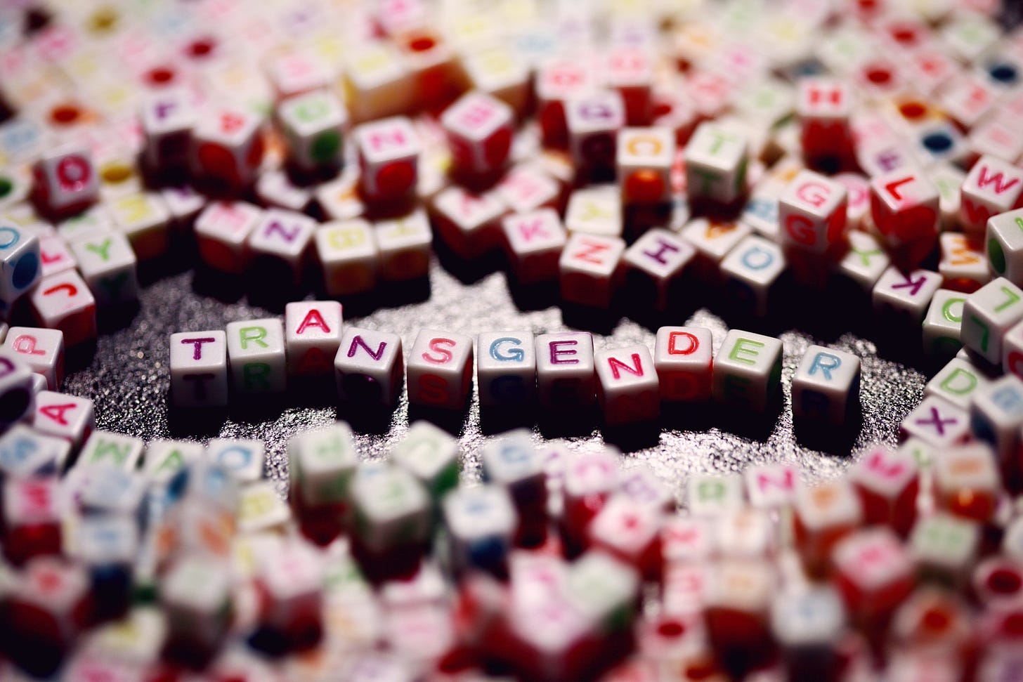 Colored blocks spelling out the word transgender