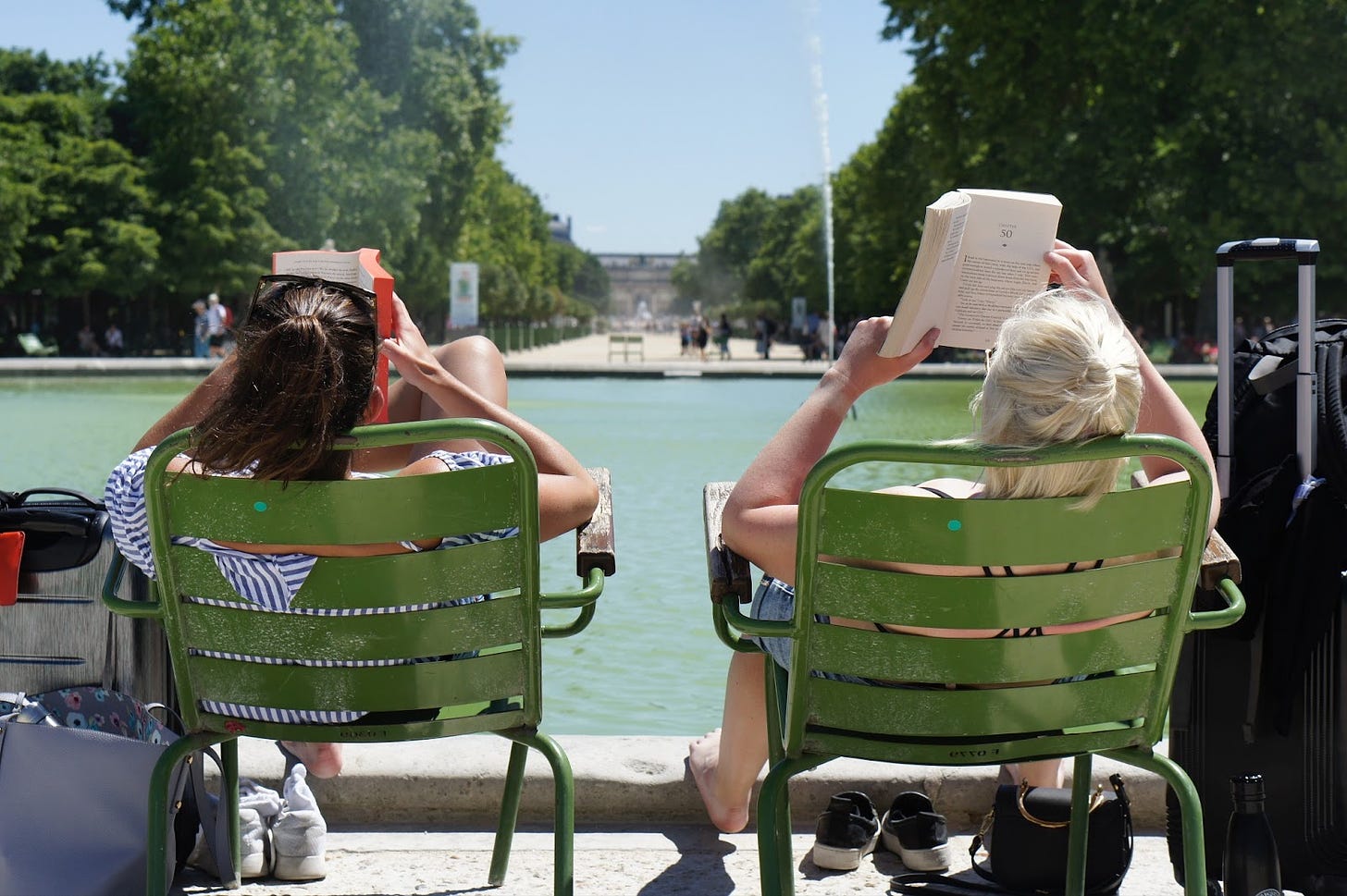 Two women reading books in the sunshine