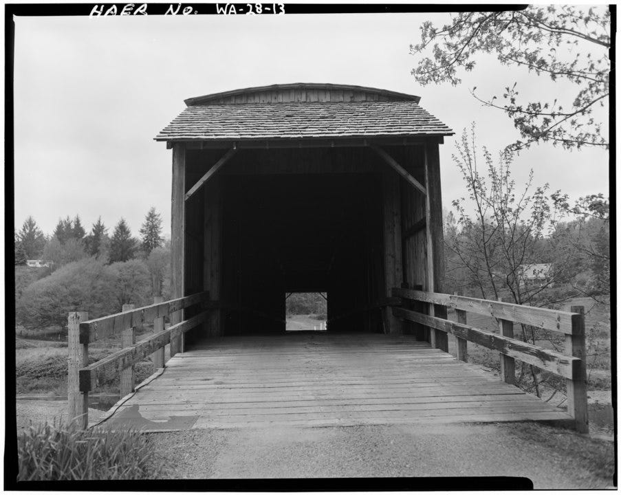 black and white image of wooden covered bridge