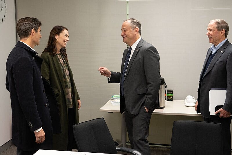 a woman (Ardern) and three men in an office