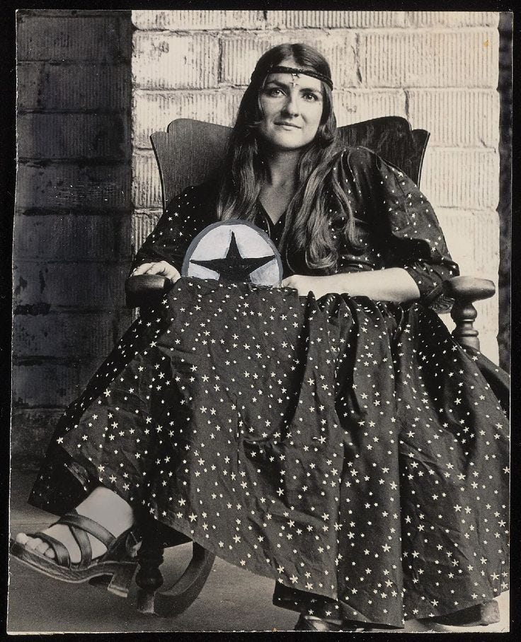 This may contain: an old black and white photo of a woman sitting in a rocking chair holding a star