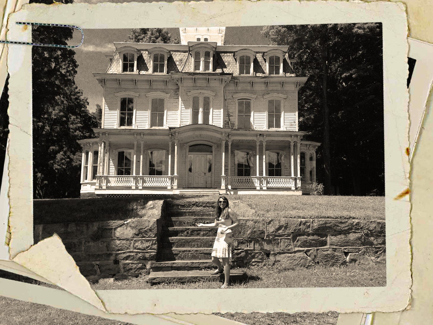 Black and white photo of a smiling woman in front of an old Victorian house. Black and white photo of a smiling woman in front of an old Victorian house.