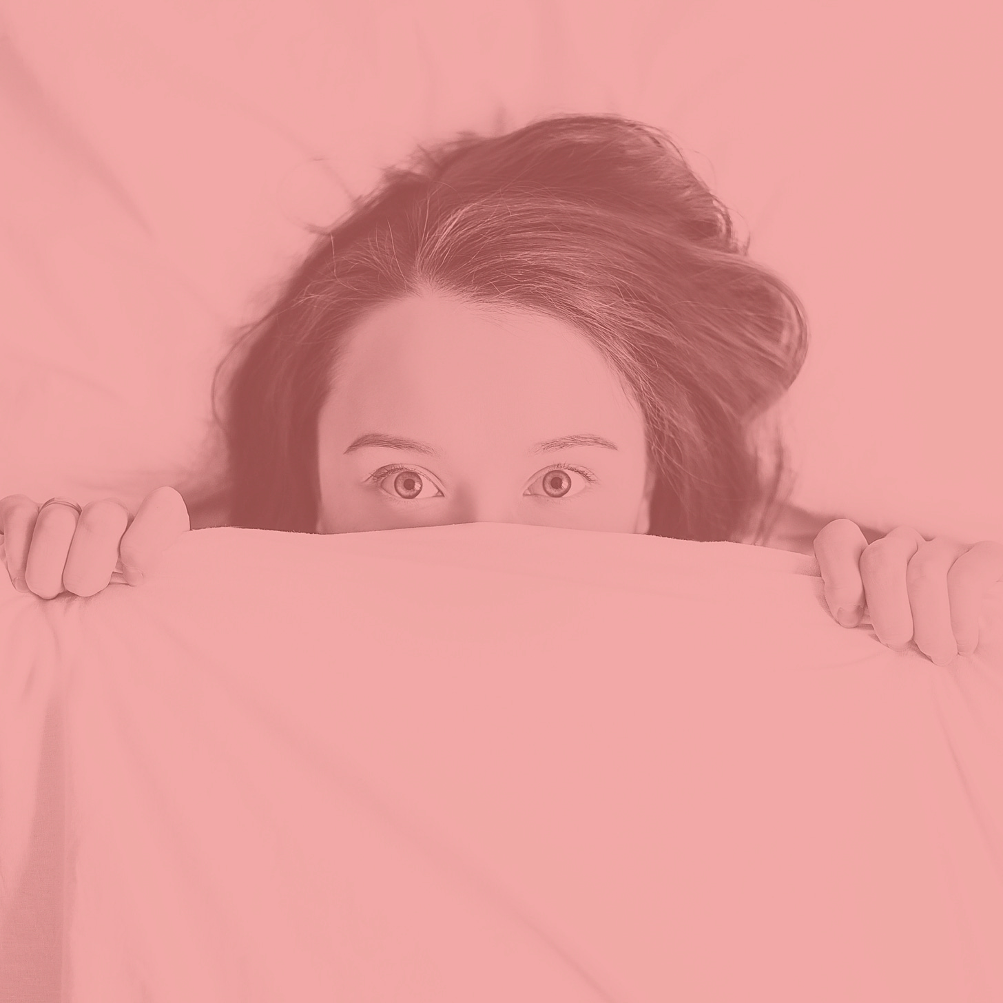 woman under blanket peeking out