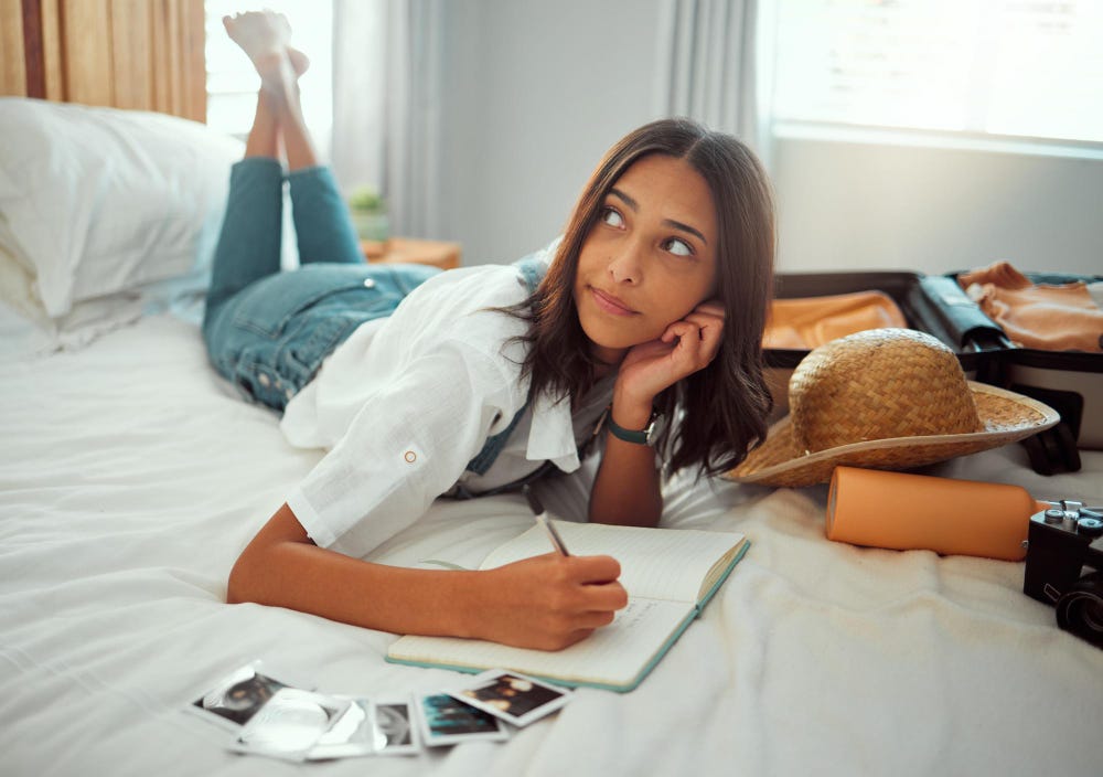 oung tanned woman journaling in a morning.