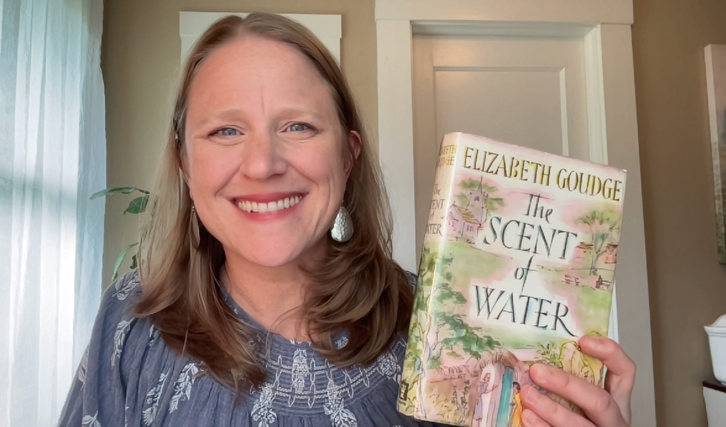 Julie Witmer with a hardback copy of The Scent of Water by Elizabeth Goudge