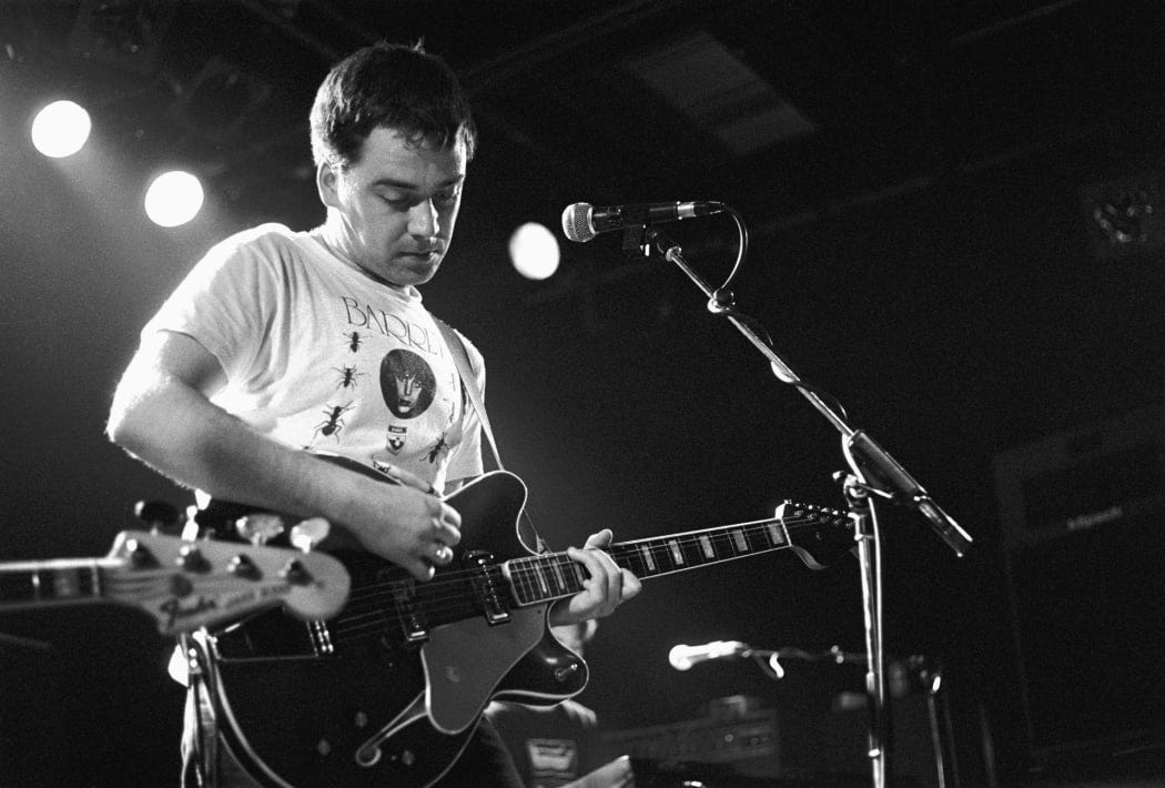 The Chills perform in Amsterdam in 1989, Martin Phillipps showing off his T-shirt power. (photo by Frans Schellekens/Redferns)