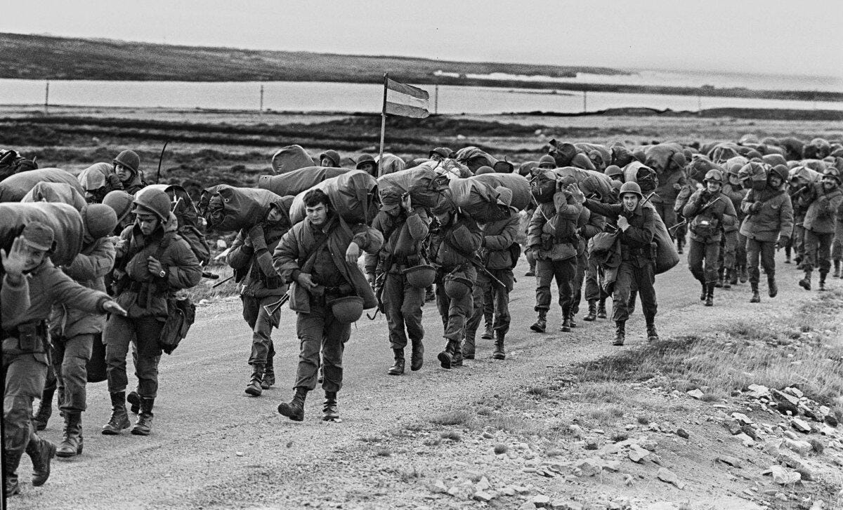  Argentine soldiers are seen on their way to occupy the captured Royal Marines base in Puerto Argentino/Port Stanley on April 13, 1982, a few days after the Argentine military dictatorship seized the islands Malvinas/Falklands, starting a war between Argentina and the United Kingdom. (Daniel GARCIA/AFP via Getty Images)