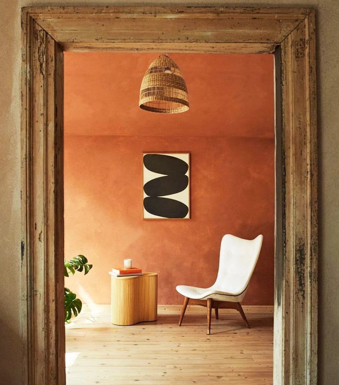 rustic orange painted wall set within the natural wood door frame