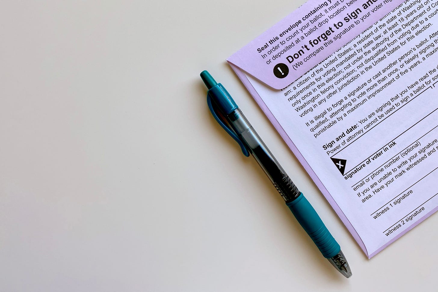 A pen sits beside a mail in ballot.