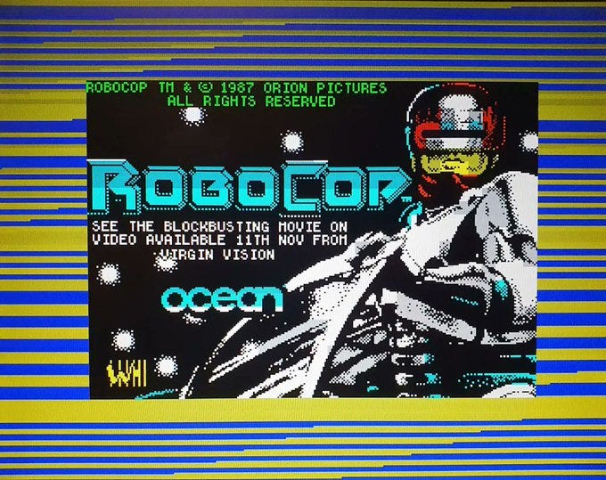 A picture showing the loading screen on a ZX Spectrum, with distinctive blue and yellow stripes around the main image.