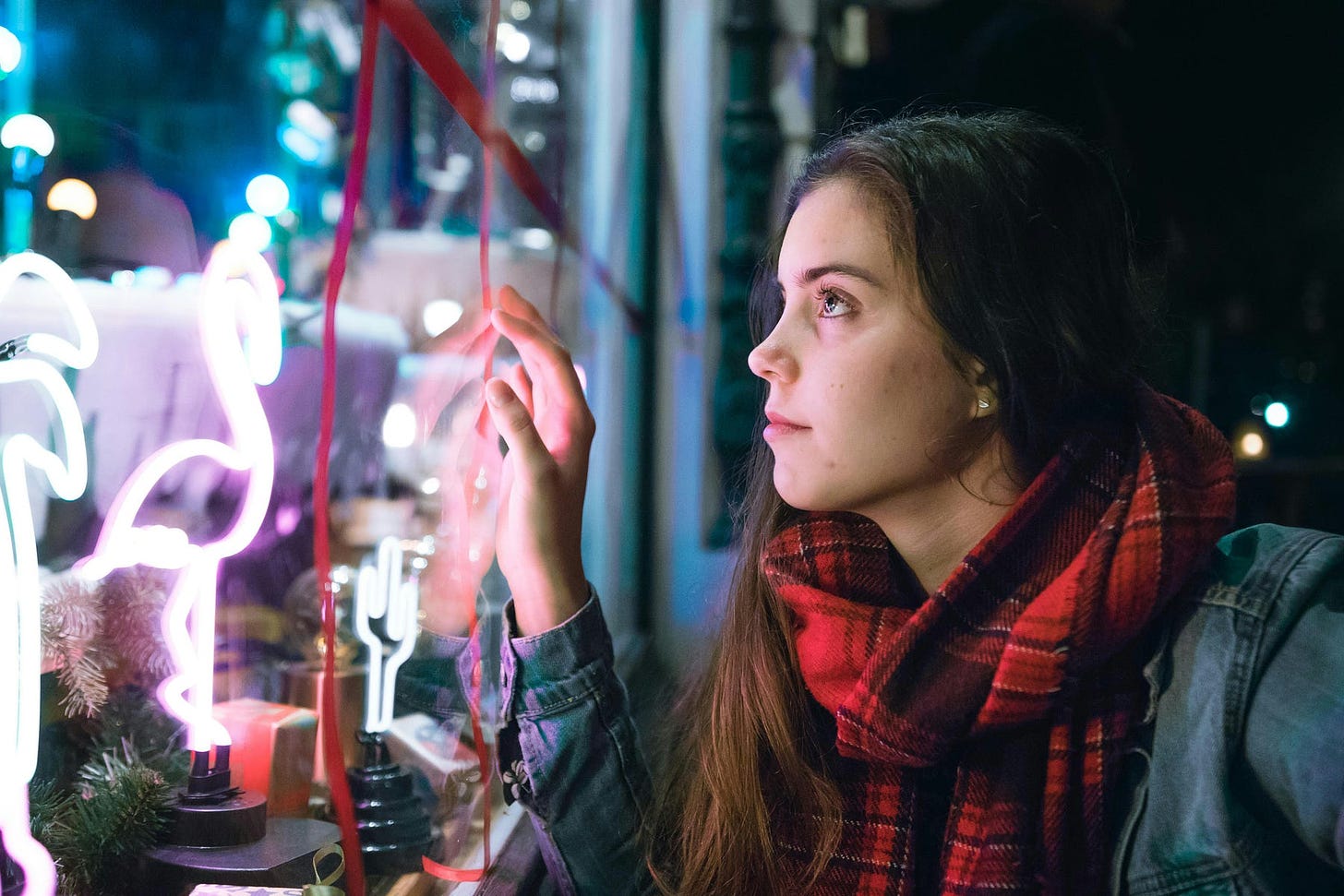 Girl looking at a window display in amazement.