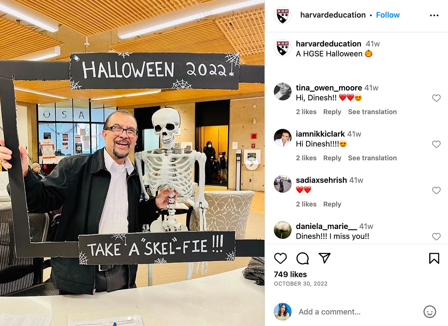 Photo of someone holding a skeleton and sign that says "Halloween 2022 Take a Skel-Fie" Likely someone who works at Harvard!