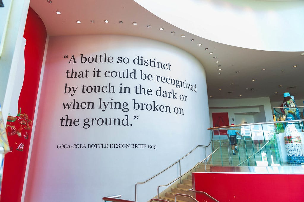 Coca-Cola Bottle Design Brief | A giant quote on the wall at… | Flickr