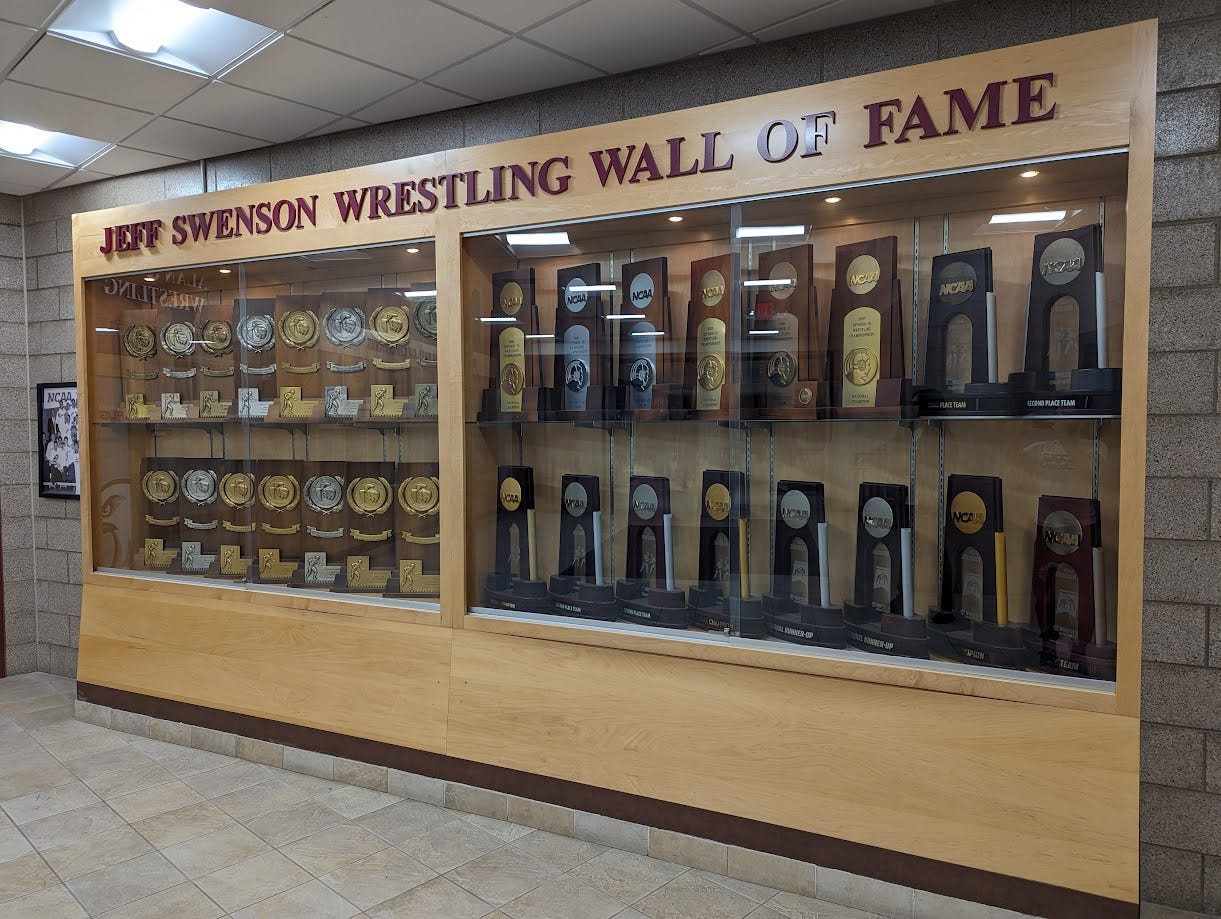 The Jeff Swenson Wrestling Wall of Fame, including over 30 trophies