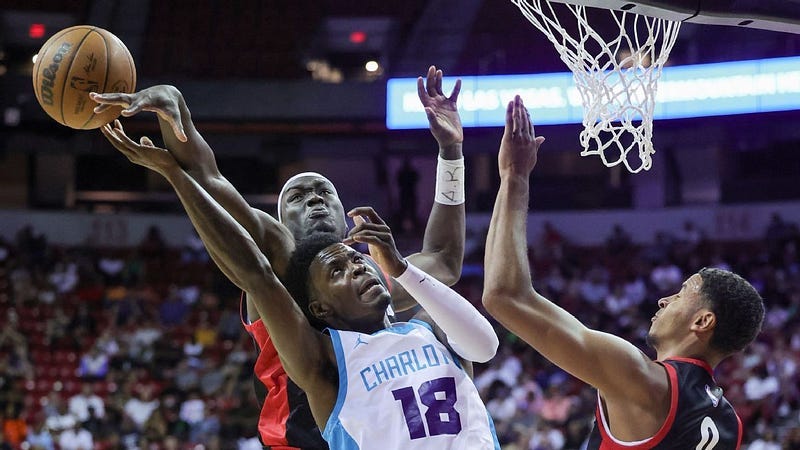 Duop Reath blocking the shot of a Charlotte Hornets player.