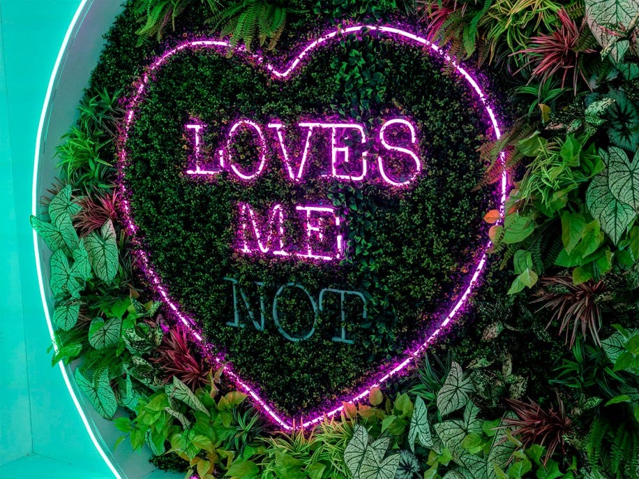 A heart-shaped neon sign at the Love Island villa reads Loves Me Not