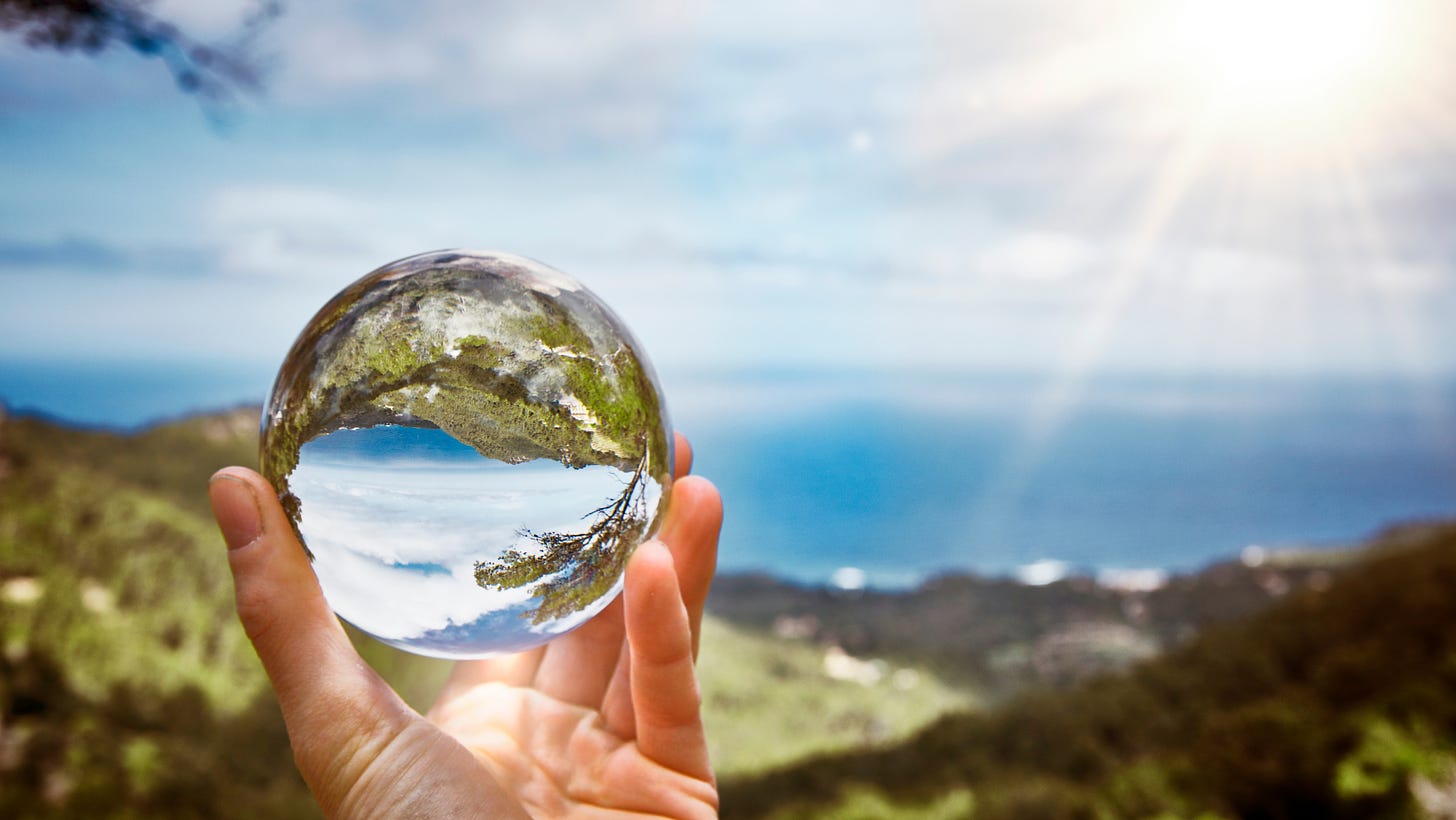 The image shows a crystal ball in a hand. It is representative of future prediction. The image is part of the article titled “Is it possible to predict the future?” published on https://rationalastro.org. The article is written by Anish Prasad who is an IIT Engineer, an IPS officer and passionate Astro-Spirituality researcher and practitioner.