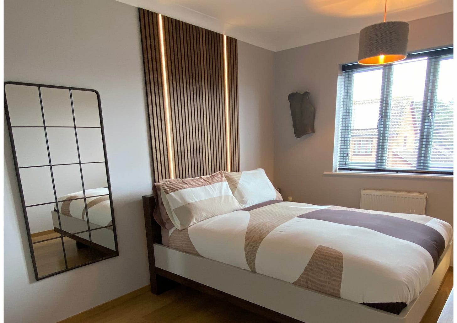 bedroom transformation with added wood panelling above the bed