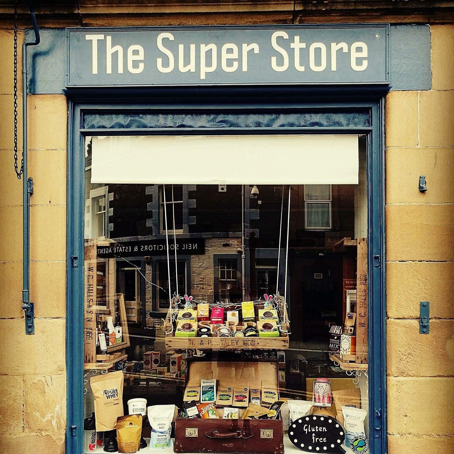 May be an image of hat shop and text