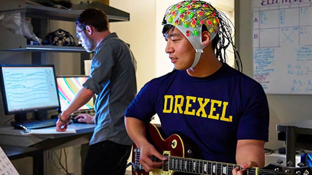 Yongtaek Oh plays the guitar while his electroencephalograms (EEGs) are recorded in the Creativity Research Laboratory. Image courtesy of Drexel University
