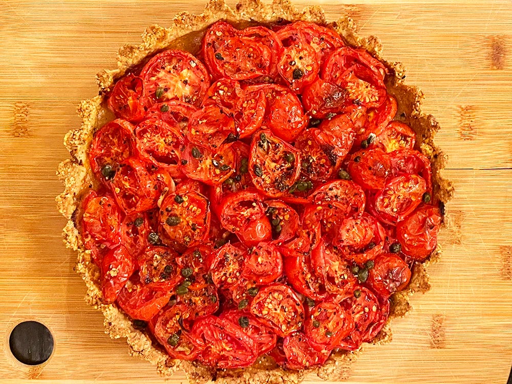 A fresh tomato tart topped with capers A fresh tomato tart topped with capers