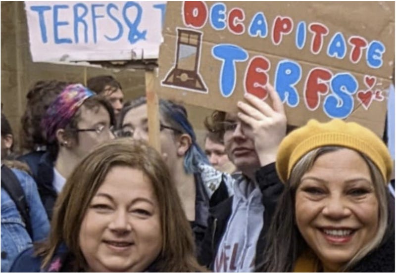 A group of people holding signs

Description automatically generated