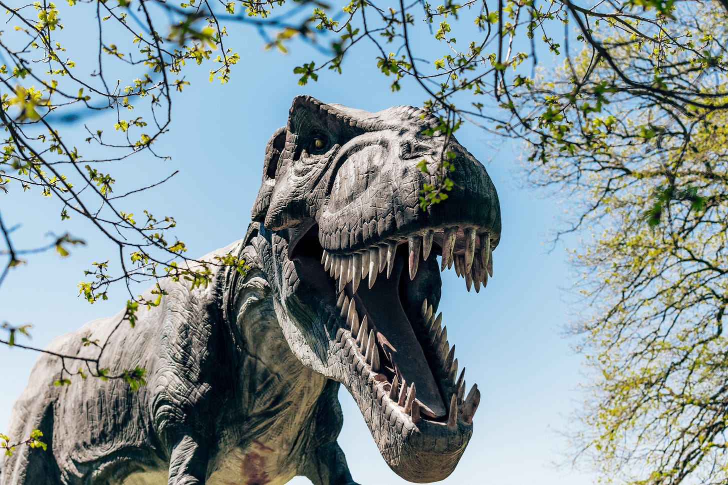 A giant dinosaur screams out above the trees.