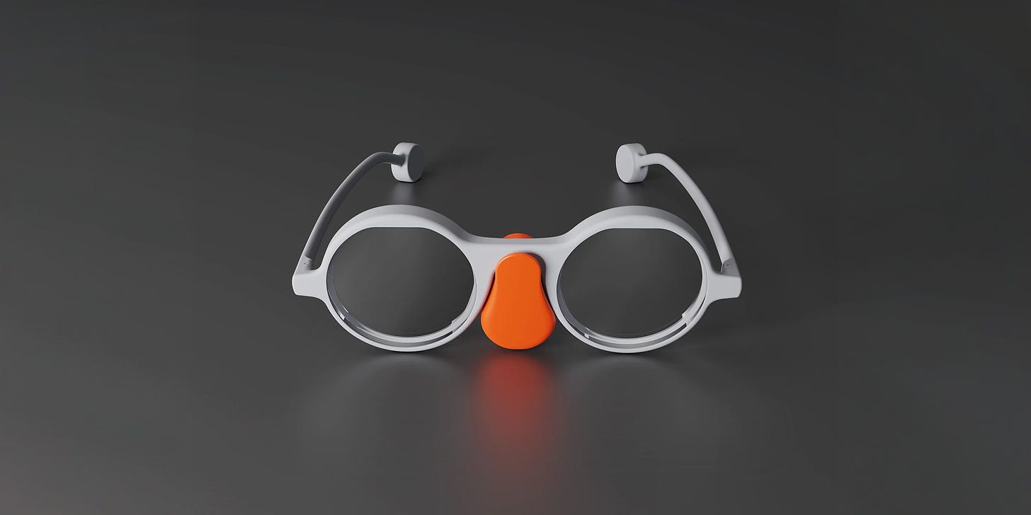 A pair of glasses with an orange charger below the bridge that looks like a comedy fake nose