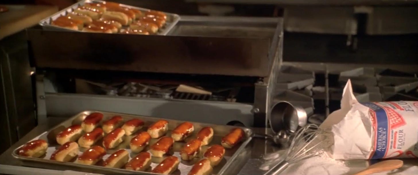 Movie still from Simply Irresistible. Two trays of caramel eclairs sit in a kitchen next to baking ingredients.