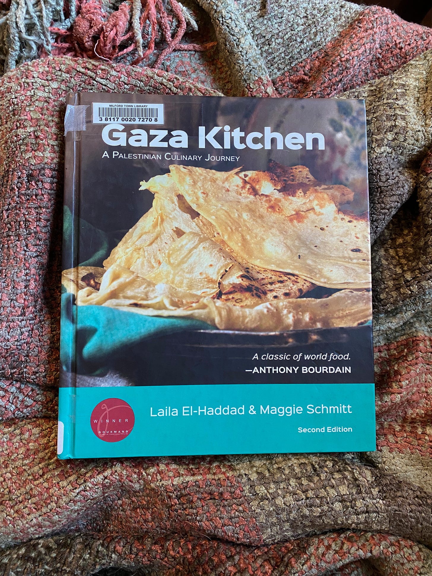 The Gaza Kitchen on a brown and green blanket.