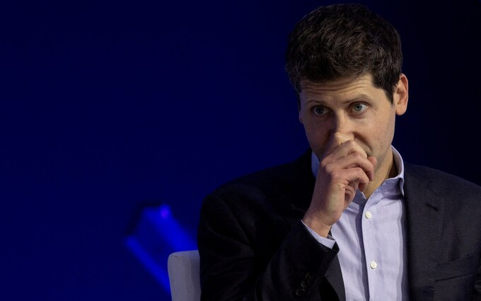 Sam Altman, OpenAI former CEO, with his hand over his mouth looking worried