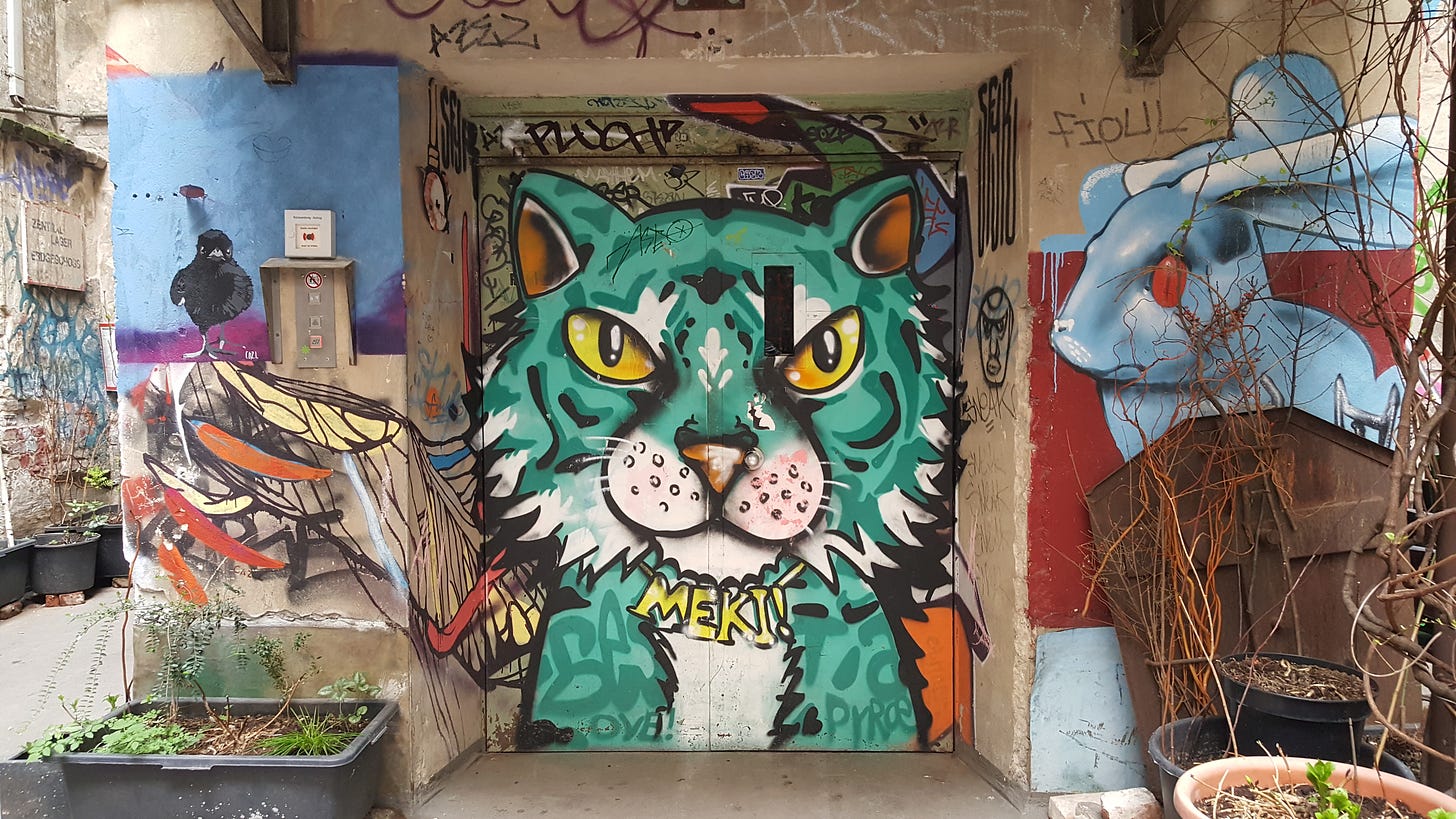 A lift door graffitied with a blue tiger