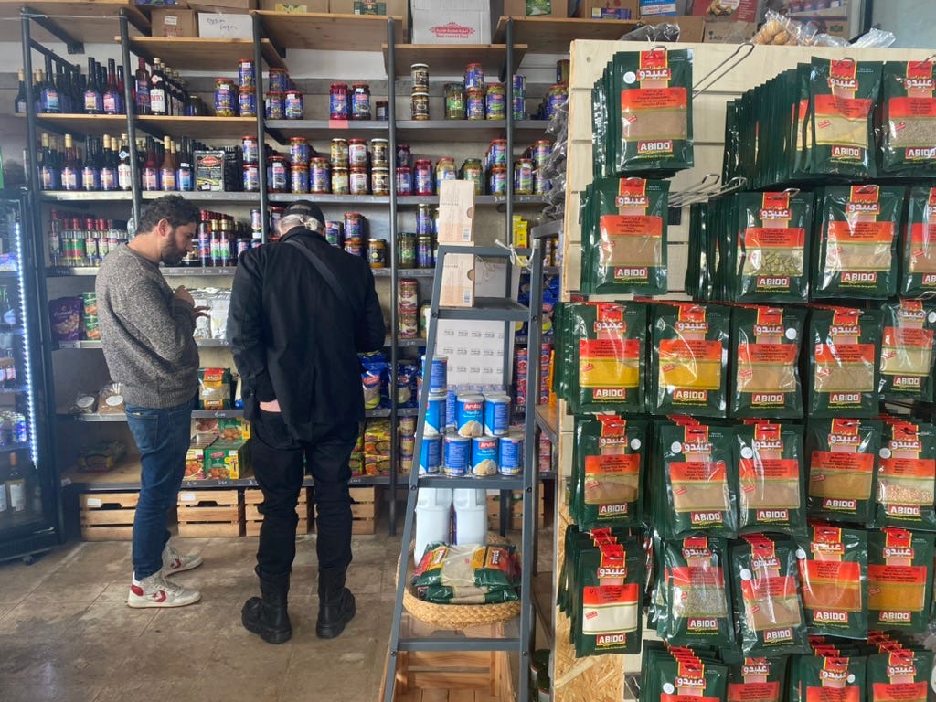 Two men in a Palestinian food shop