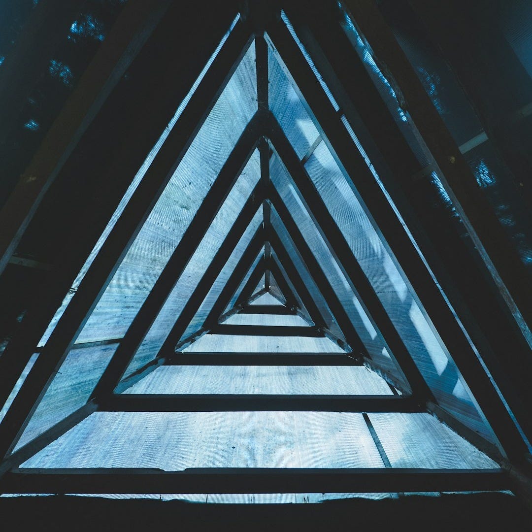 a group of triangular shaped windows in a building a group of triangular shaped windows in a building