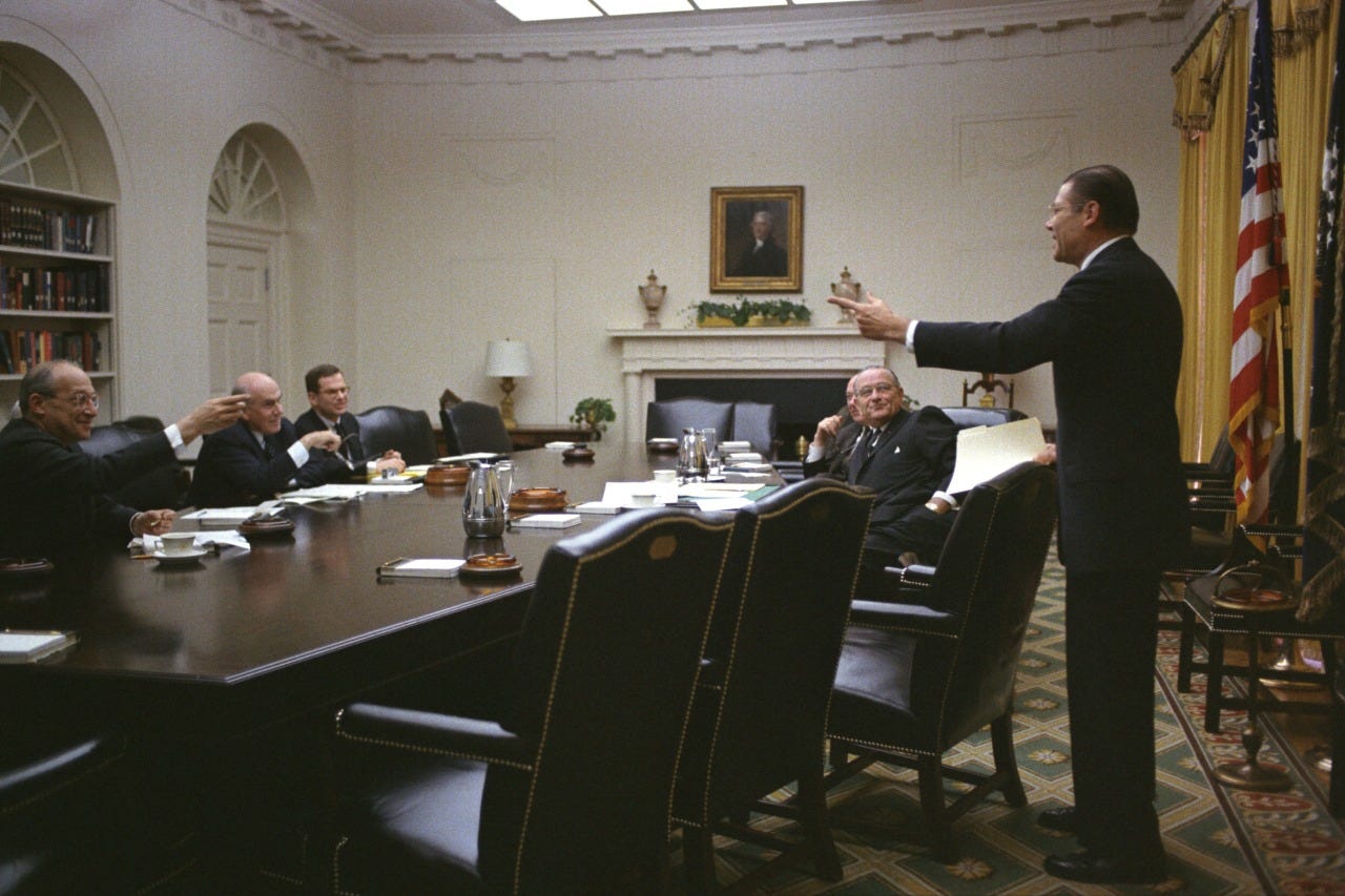 March 8, 1967. Meeting in the Cabinet Room, White House. (L_R) Walt Rostow, John McCloy, Francis Bator, Sec. Dean Rusk, President Lyndon Baines Johnson, and Sec. Robert McNamara LBJ Library photo #C4651-25, public domain.
Bottom left: Seated at table...