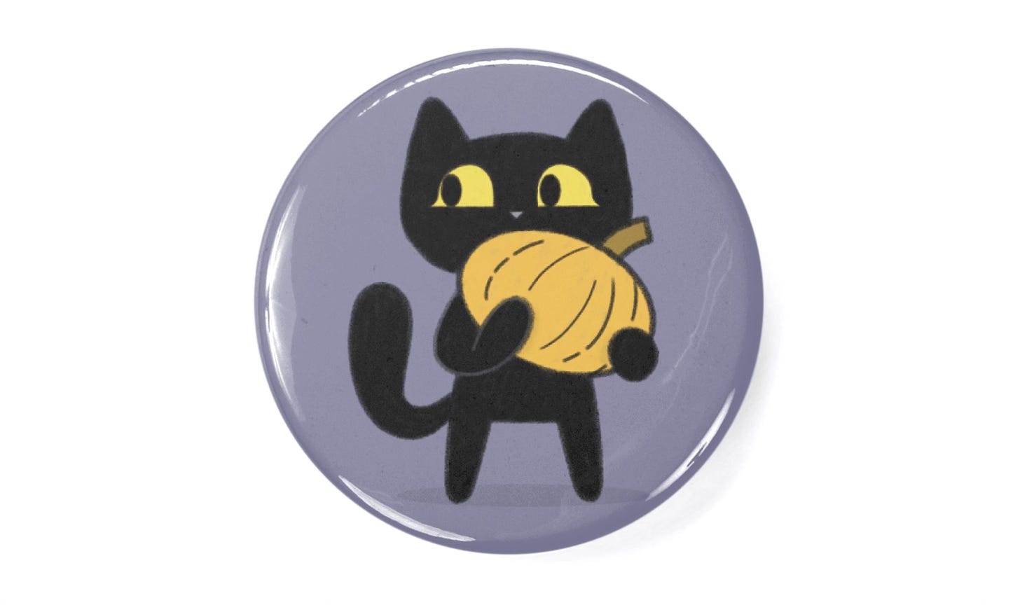 a button with the spooky cute cat design printed on it