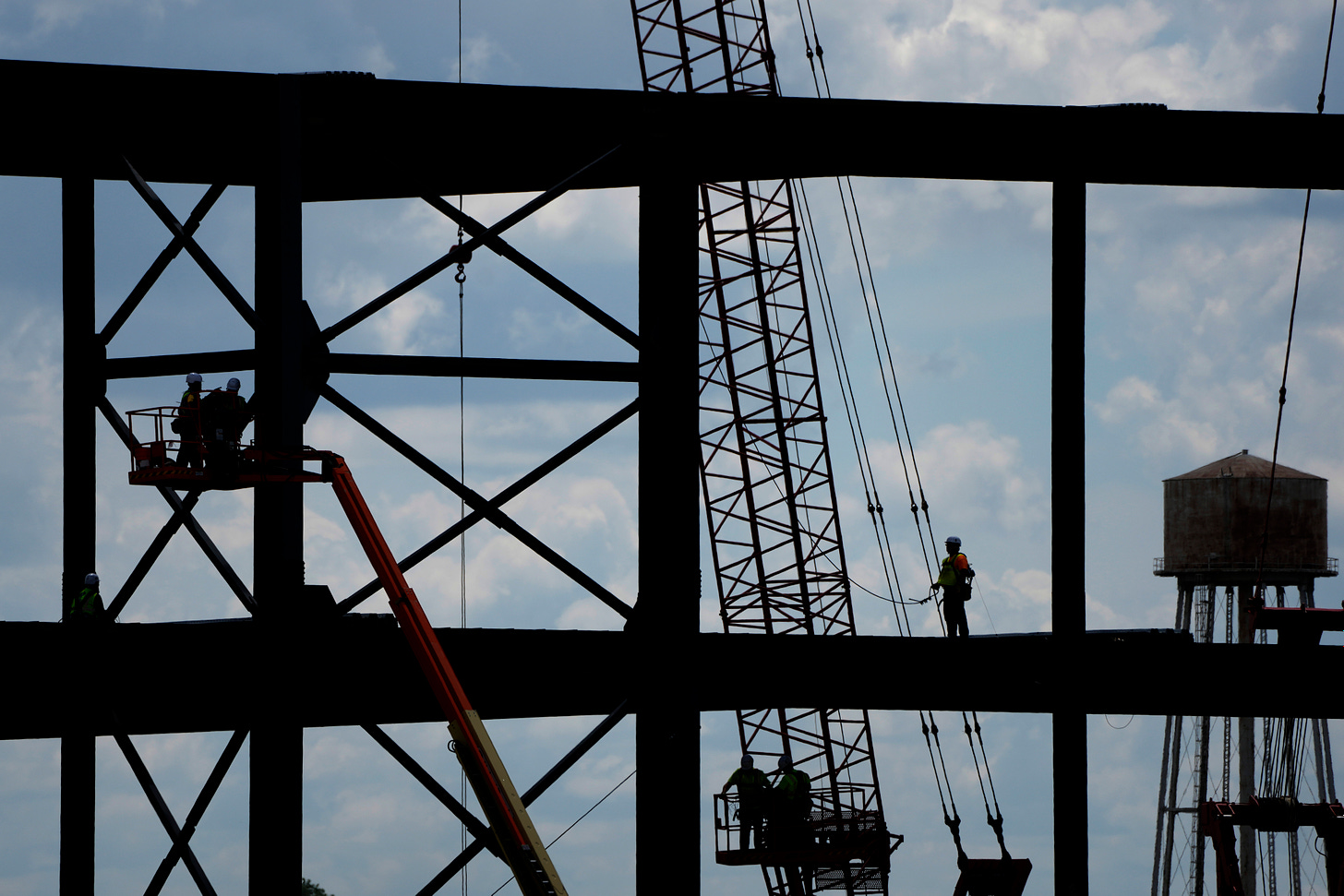 Iron workers construct the frame of a Panasonic electric vehicle battery plant in 2023 near DeSoto, Kansas.