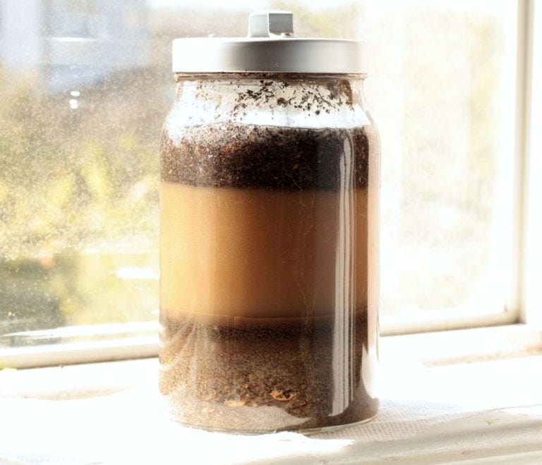 photo of sediment jar experiment - showing layers of sediment having settled after several days