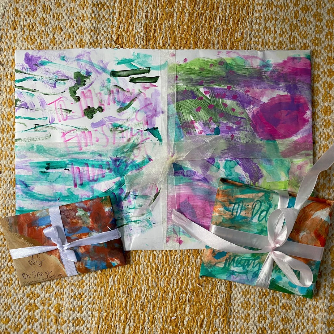 Gifts wrapped in colorful scrap painted paper. 