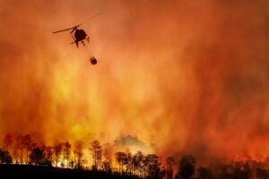 Major fire with helicopter dropping water