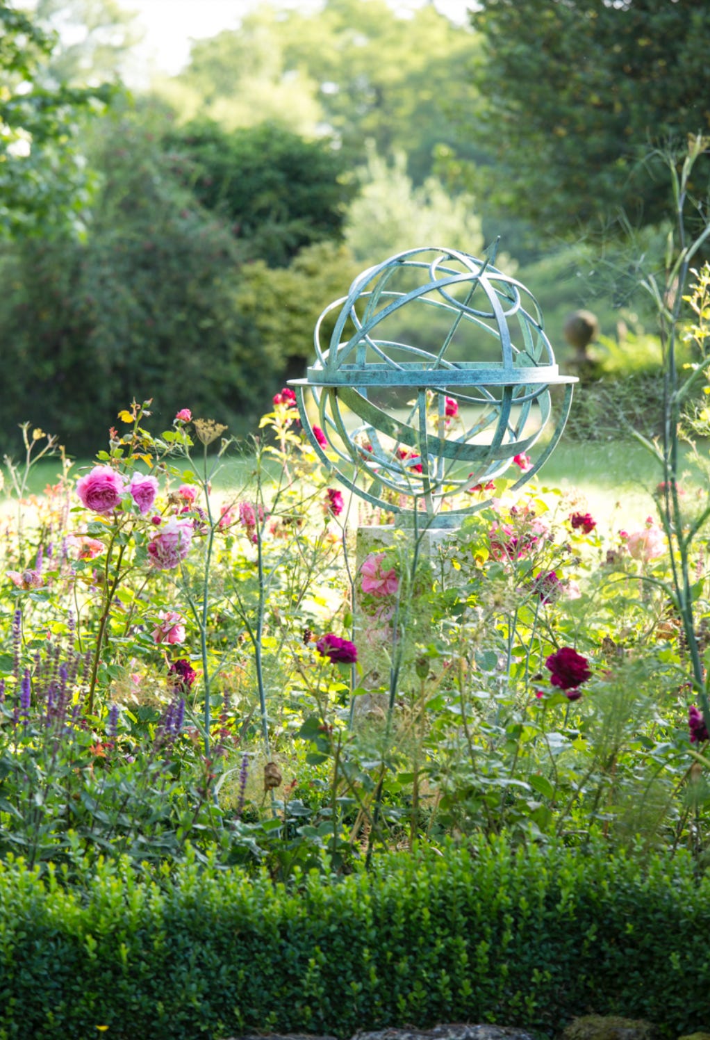 A sundial and roses in a country garden