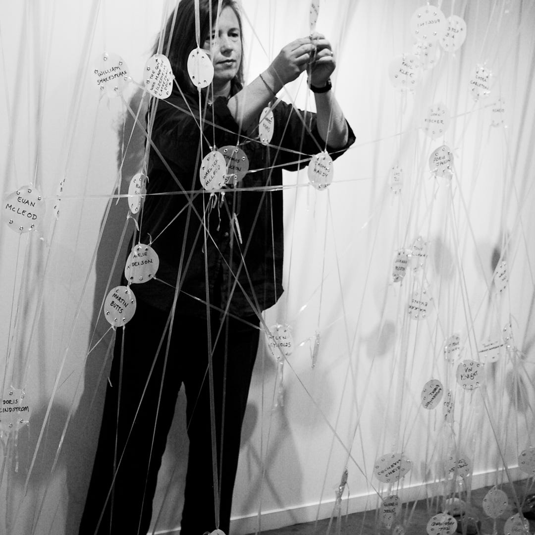 Helen Reynolds installing a network exhibition