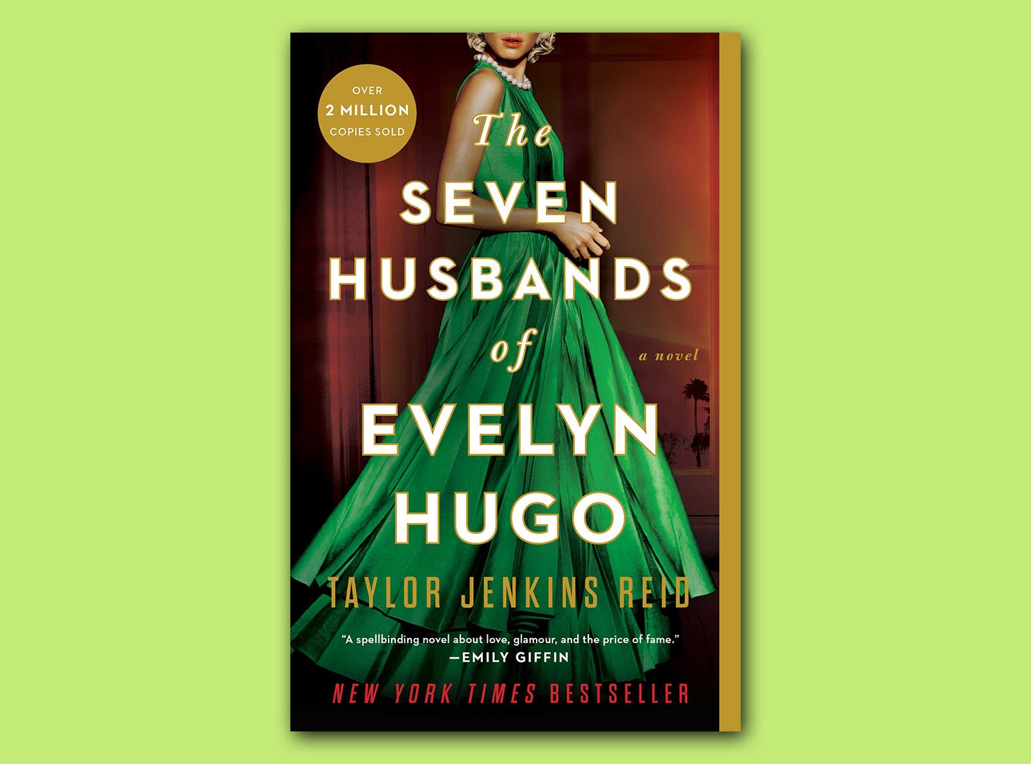 The front cover of the book "The Seven Husbands of Evelyn Hugo" by Taylor Jenkins Reid is superimposed on a light green block colour background. The book cover shows a glamorous woman in a shiny green ballgown with a pearl necklace.