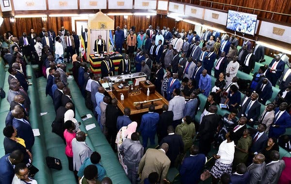 Members of Uganda’s Parliament standing in their chamber.